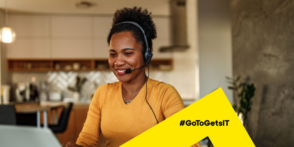 IT support technician working from home on a laptop using remote support software to teach an end user how to self-serve similar issues in the future