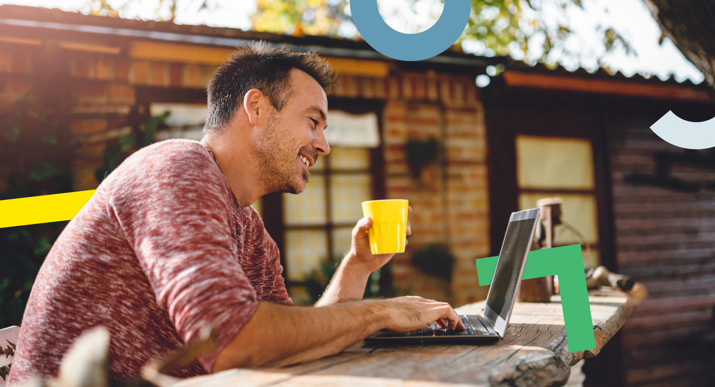 Person sitting outside cabin in the sun happily on laptop computer representing why entrepreneurs deserve easier, affordable technology.