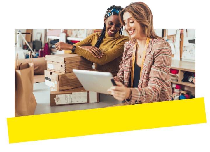 Business owner reviewing customer details on tablet with colleague using GoTo Connect Customer Engagement.