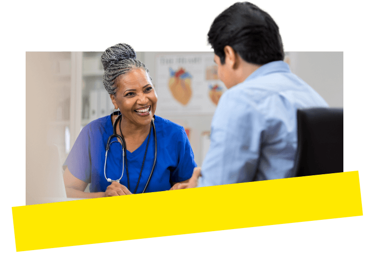 A medical office manager discussing with a healthcare provider, utilizing GoTo Connect integrated with health records.